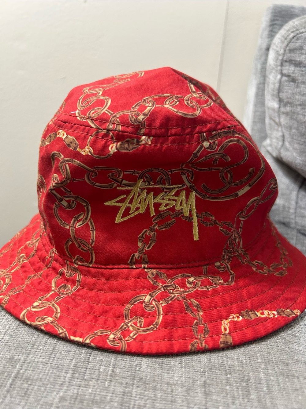 Stussy Red Bucket Hat with Gold Chain Motif